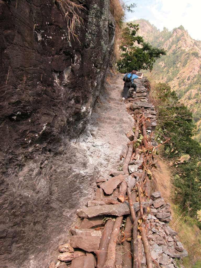 Manaslu 02 07 Dangerous Trail The trail climbs onto a ridge above huge rapids on the Buri Gandaki. Much of the trail is blasted out of vertical rock walls - steady on your feet and don't look down while you�re climbing the stone steps cut out of the mountainside. We arrived at the Gurung village of Labubesi (880m) at 15:00. A Maoist arrived at 17:30! She was a young, very mannerly, and soft-spoken young woman. She said she was collecting a 100 rupee per day tax for the Maoist Government. I dutifully paid her 1600 rupees and she gave me a receipt. She also asked for a donation. I refused, and she left.